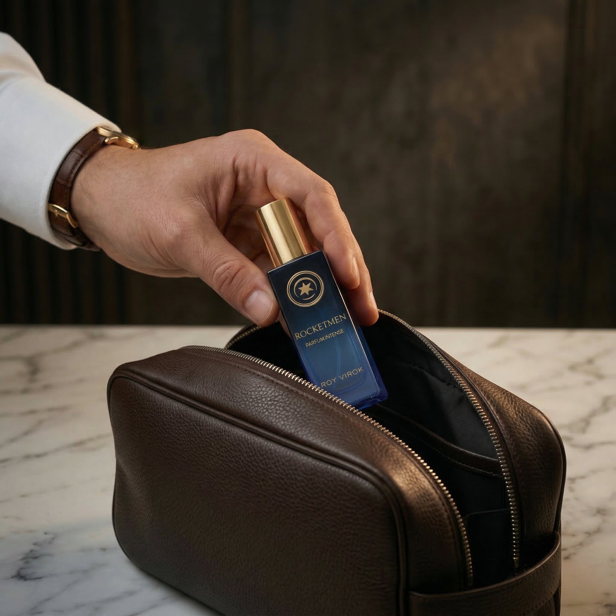 ROCKETMEN Discovery Size 15 ml by ROY VIROK being placed inside a leather travel bag, a compact men’s fragrance for carrying anywhere.
