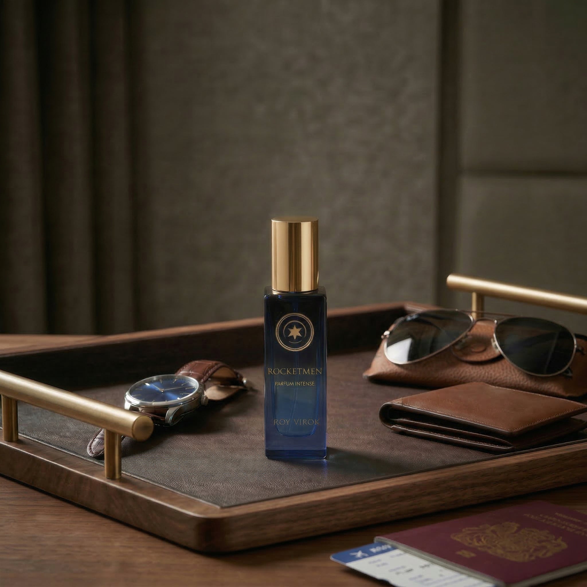 ROCKETMEN Discovery Size 15 ml by ROY VIROK on a travel tray with watch, sunglasses and passport, a compact men’s fragrance for travel.